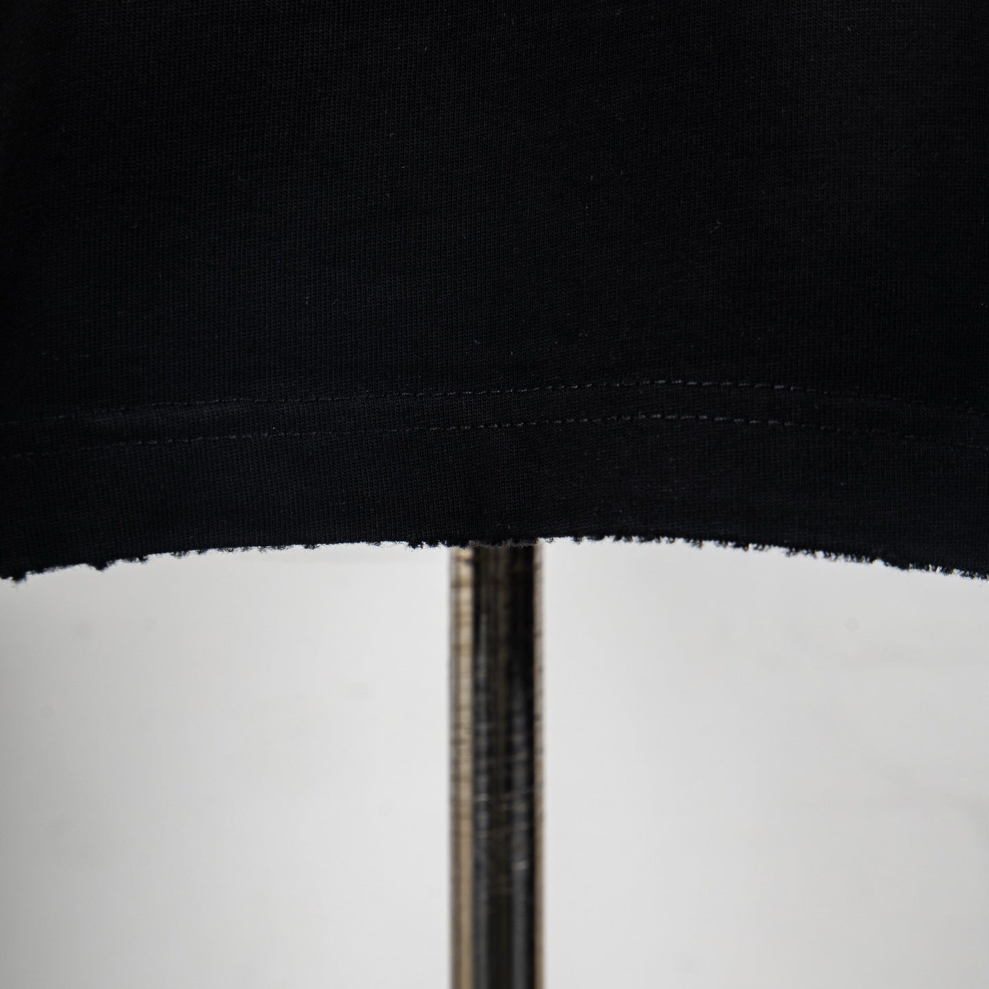 Black T-shirt hem with double-stitched finish