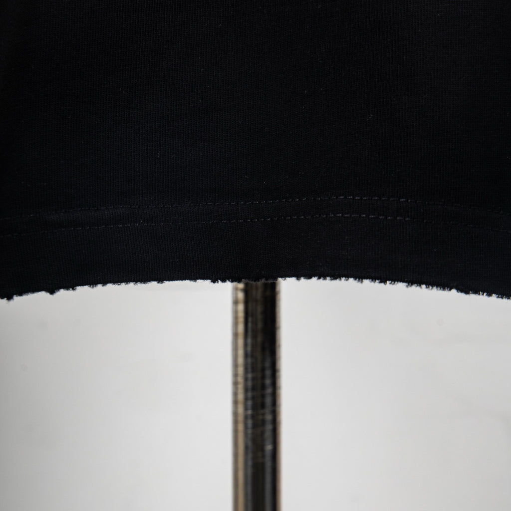 Black T-shirt hem stitching close-up