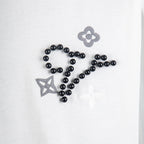 Louis Vuitton T-shirt applique detail: black bead embroidery with flower and star motifs