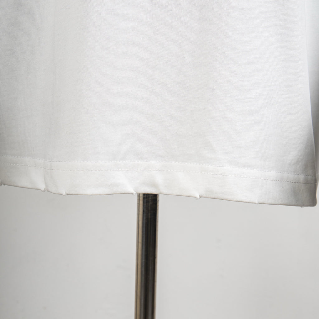 Louis Vuitton white T-shirt hem with visible stitching and drop hemline