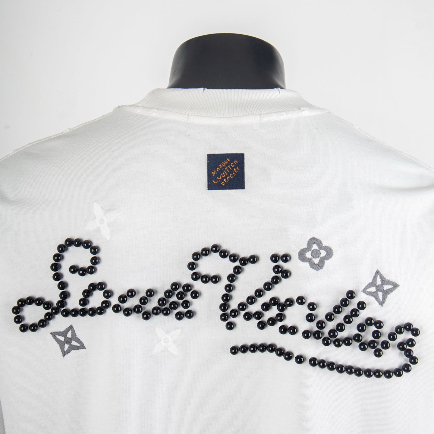 Louis Vuitton short-sleeve T-shirt back with black beaded designs and small brand patch