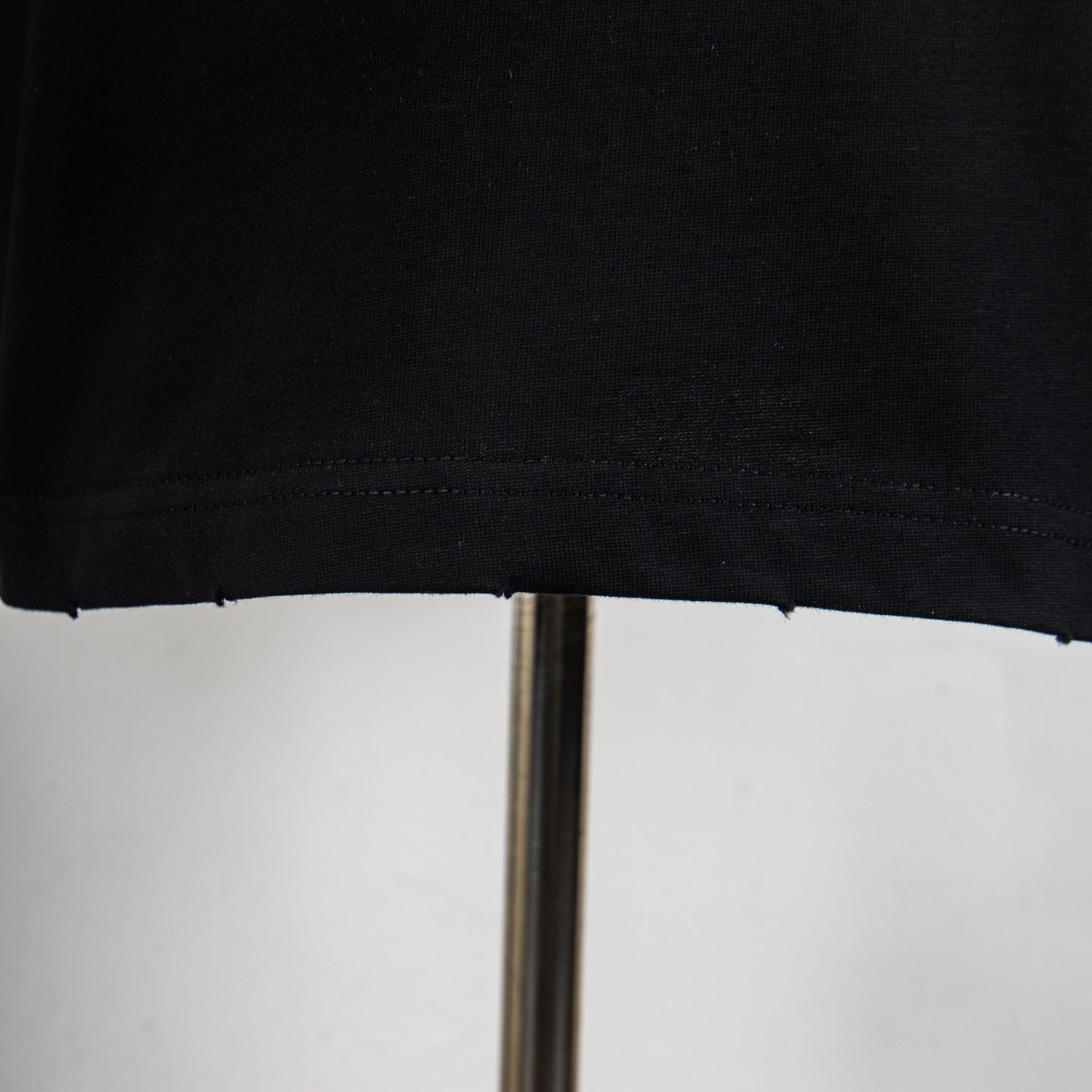 Black T-shirt hem stitching close-up