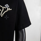 Black T-shirt sleeve with partial pearl star and flower embellishment