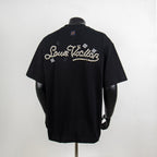 Black crewneck T-shirt with pearl embellishment script on the back