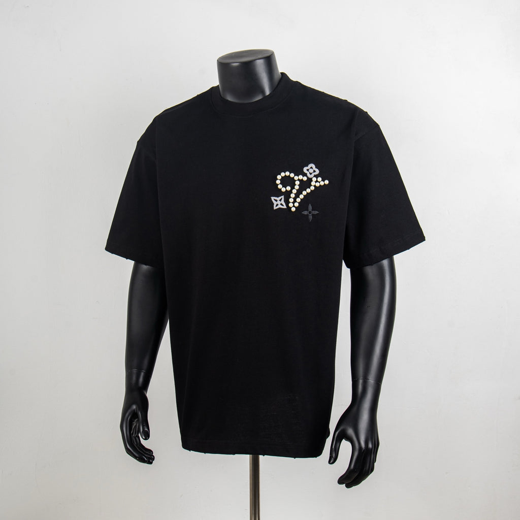 Black crewneck T-shirt with pearl and rhinestone star-flower motif on chest