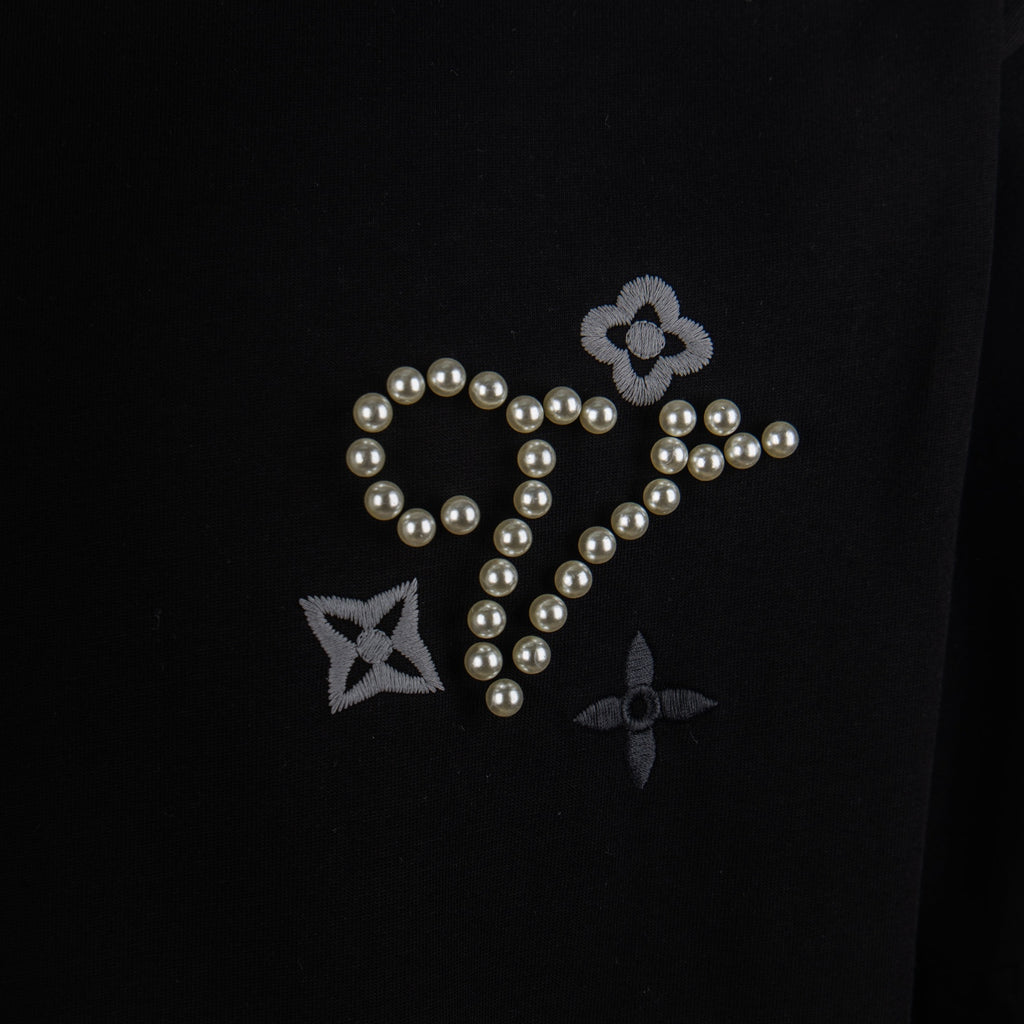 Black T-shirt with pearl and rhinestone-style star, flower, and cross motif