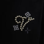 Black crewneck T-shirt front graphic with pearl cursive, stars and flower details