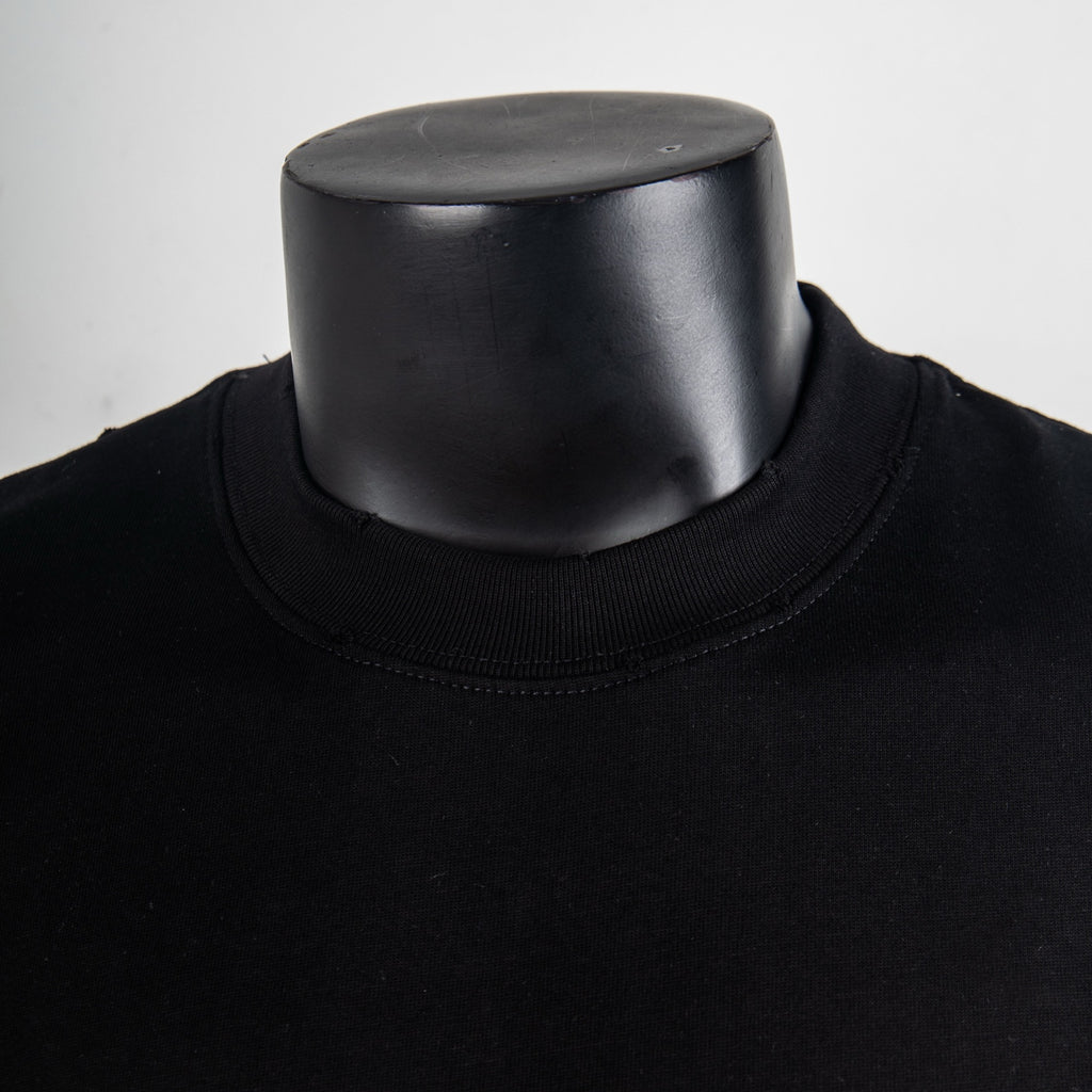 Black crewneck T-shirt neckline and ribbed collar close-up