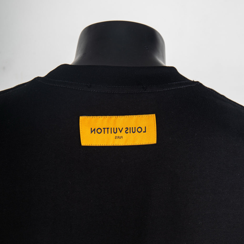 Black T-shirt with orange Louis Vuitton back neck label at the collar