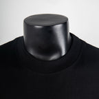 Black crew-neck T-shirt with ribbed collar and visible neckline stitching