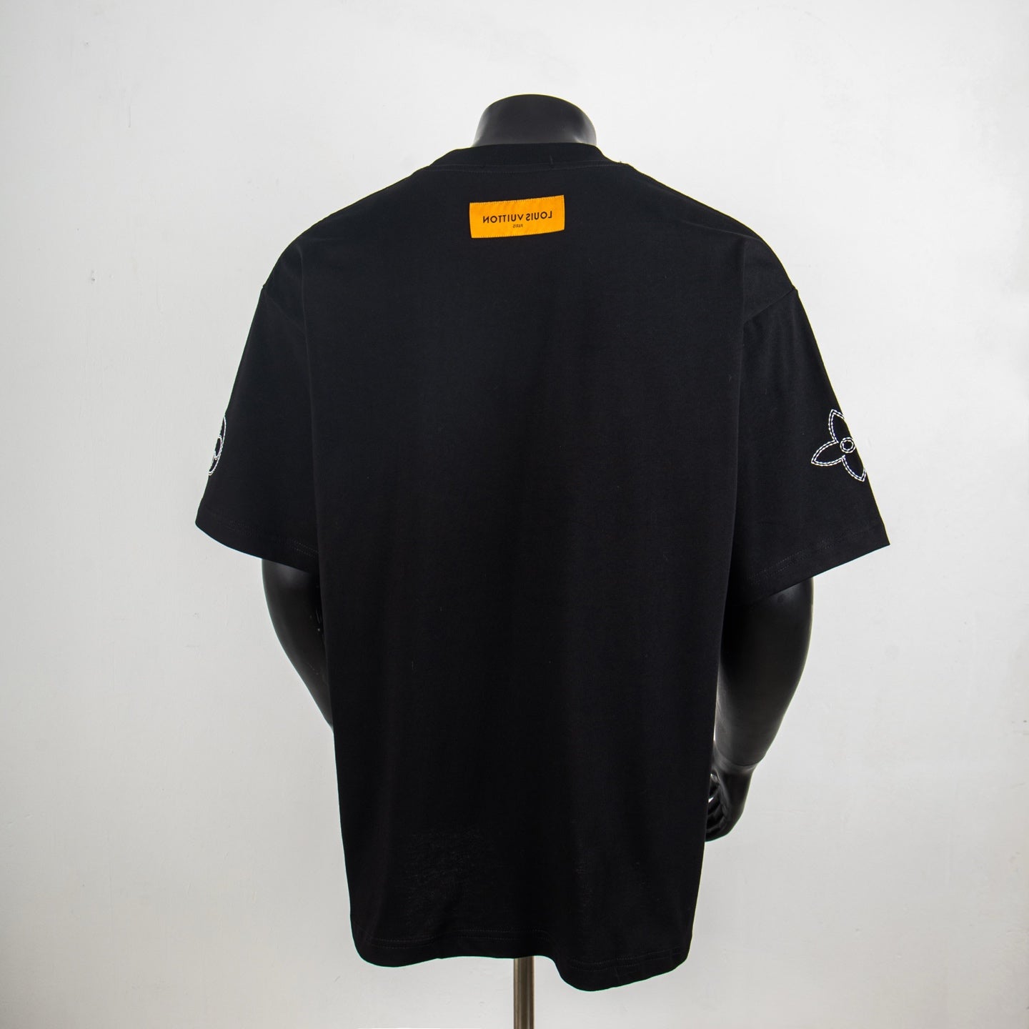 Black short-sleeve T-shirt with Louis Vuitton back neck label and sleeve emblem