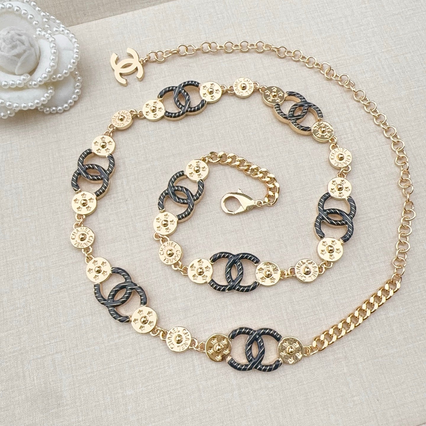Chanel chain belt on display, gold and dark blue enamel links with CC connector