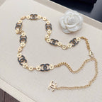 Chanel chain belt laid flat: gold and dark blue enamel link chain with CC end charm