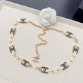Chanel chain belt with blue enamel links and gold round logo medallions