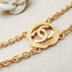 Gold-tone round interlocking CC centerpiece on a chain belt with curb links