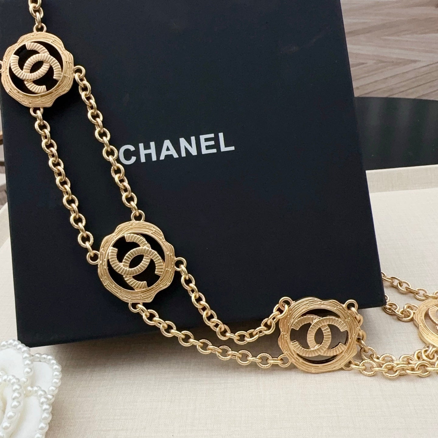 Gold-tone chain belt with three round interlocking CC medallion charms and links