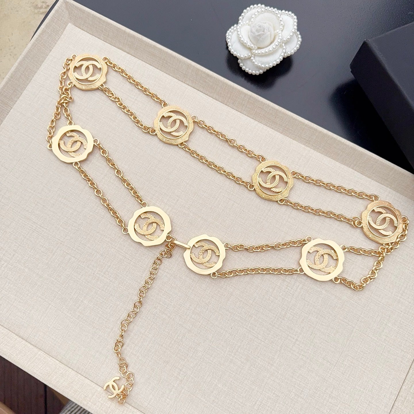 Gold-tone chain belt with round interlocking CC medallion charms and dangling end