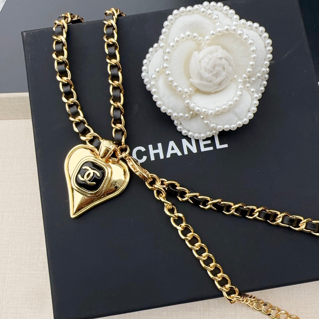 Chanel belt with gold-tone chain links, heart charm, and white camellia detail