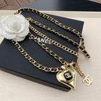 Chanel belt layered chain with bow charm, heart pendant, and CC logo tag