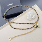 Chanel belt with gold-tone chain links, heart charm, and CC logo at center