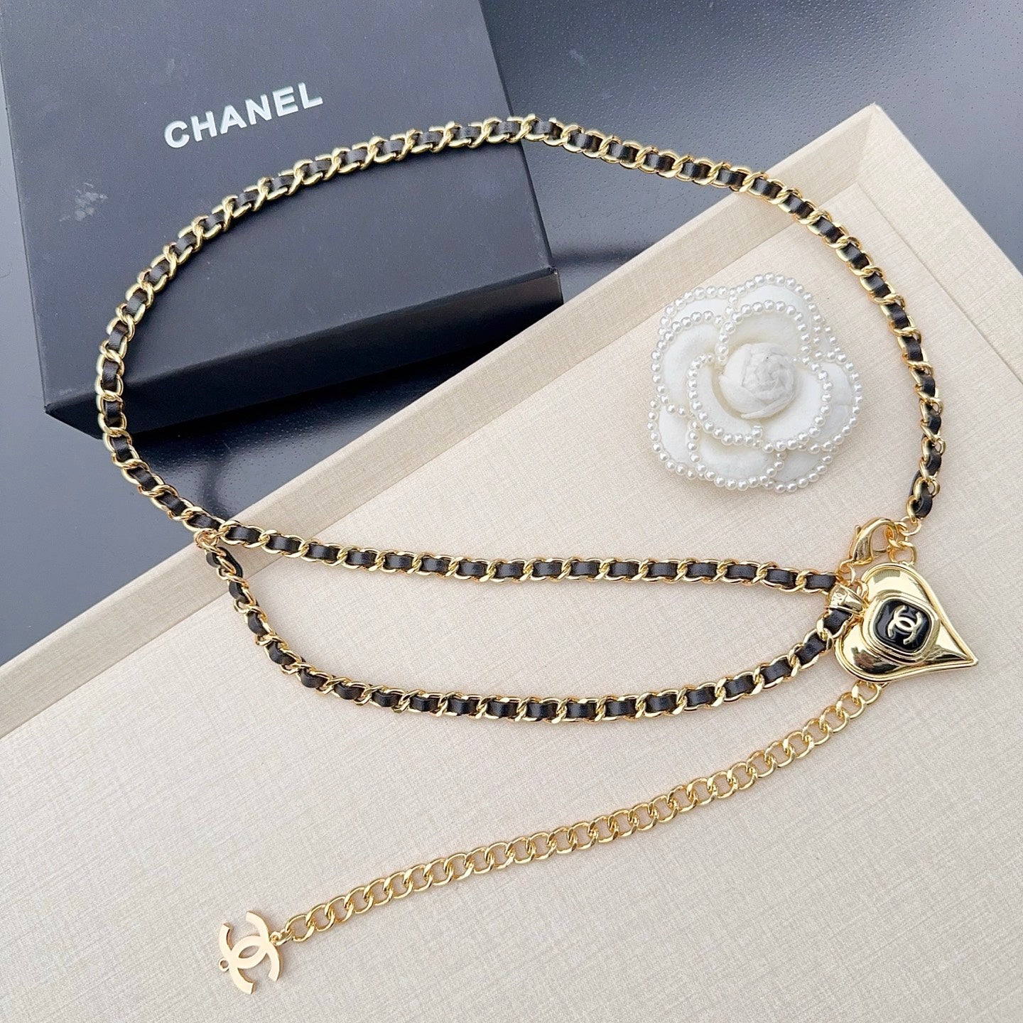 Chanel belt with gold-tone chain links, heart charm, and CC logo at center