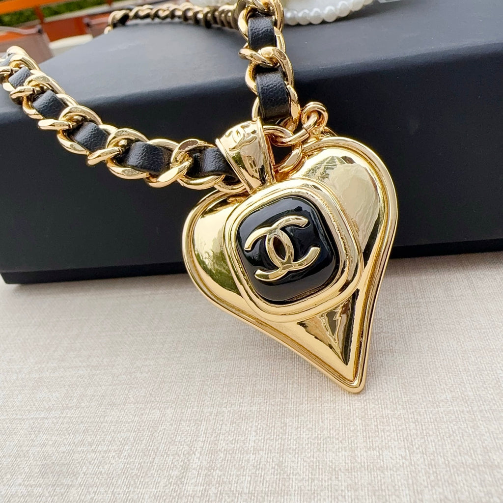 Chanel belt with gold-tone chain links and heart-shaped pendant with CC logo