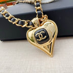 Chanel belt with gold-tone chain links and heart-shaped pendant with CC logo