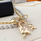 Gold and silver rhinestone belt with layered bow pendant and round clasp detail