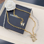 Two-tone rhinestone belt with CC charm and bow dangle, plus pearl flower accent