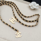 Chanel belt with gold-and-black chain links and gold CC drop charms