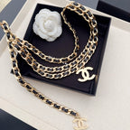 Chanel belt with layered gold-and-black chain links and gold CC charm