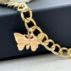 Chanel belt close-up with gold-tone chain, black links, and butterfly charm at the clasp