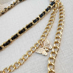 Chanel belt with gold-tone chain and black-link chain, butterfly charm on a small loop