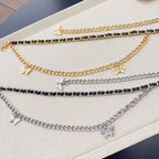 Gold and silver chain belt strands with butterfly charms for a layered look.