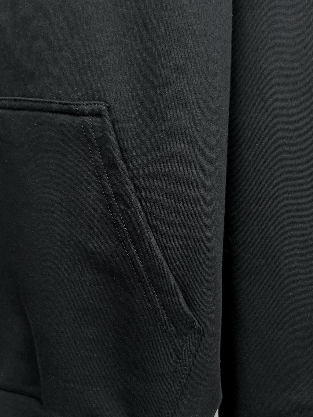Balenciaga black hoodie pocket close-up with stitched seam detail