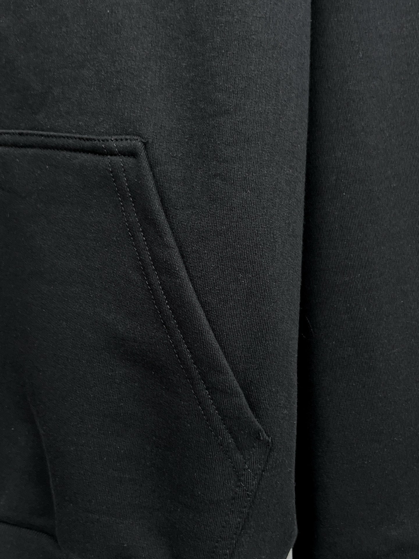 Balenciaga black hoodie pocket close-up with stitched seam detail