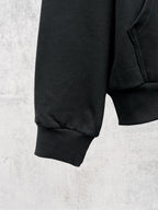 Balenciaga black hoodie quarter view with ribbed cuffs and stitched side seam