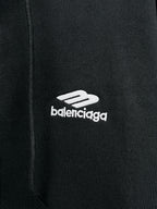 Balenciaga black hoodie close-up of zipper area with small 'balenciaga' logo
