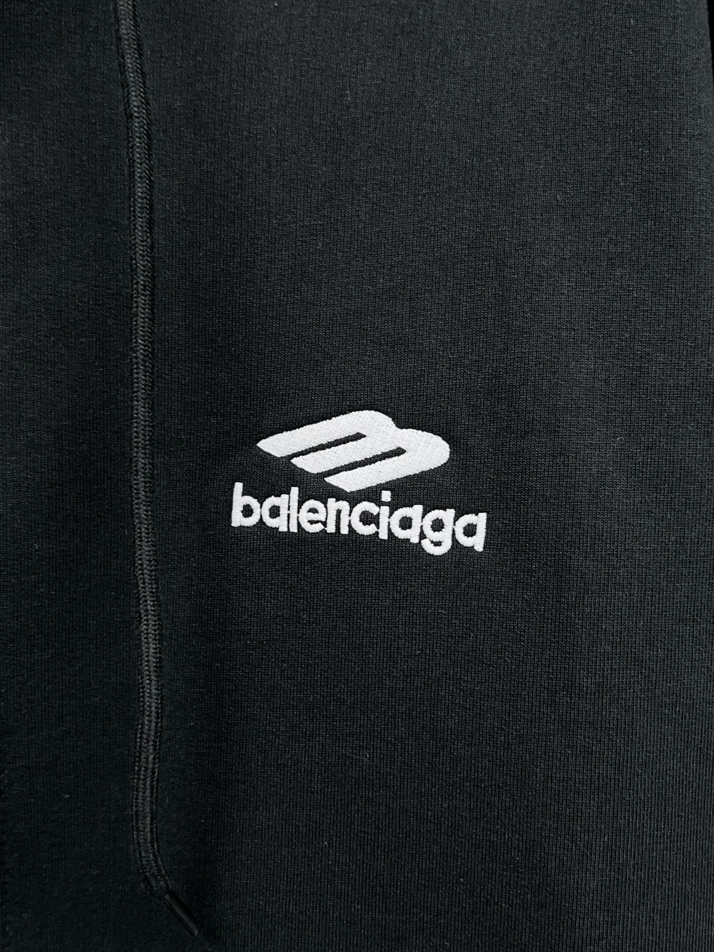 Balenciaga black hoodie close-up of zipper area with small 'balenciaga' logo