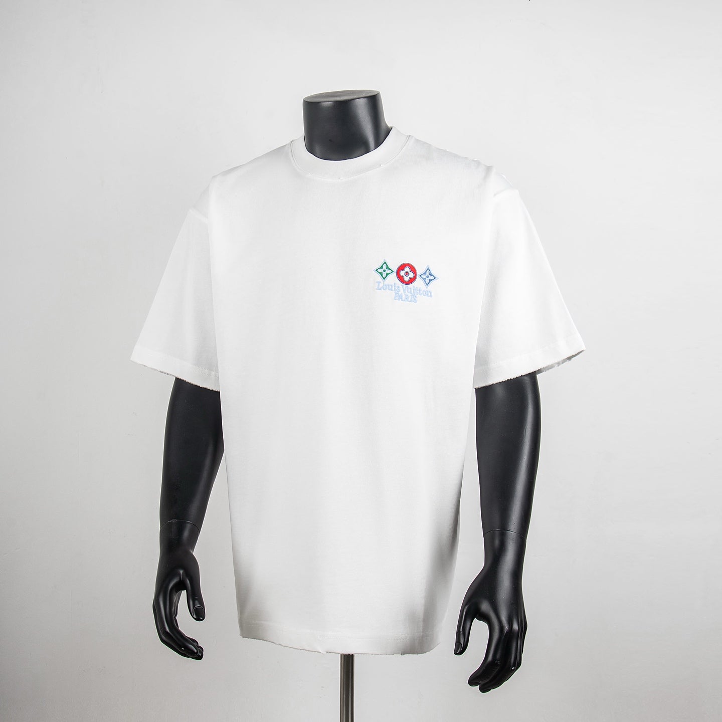 White short-sleeve T-shirt with small multicolor logo graphic at chest