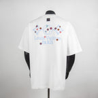 White short-sleeve T-shirt with multicolor back print and blue neck tag