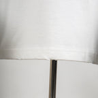 White T-shirt bottom hem with visible seam stitching
