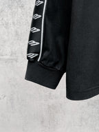 Black long-sleeve shirt cuff with white Balenciaga logo stripe sleeve
