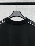 Black long-sleeve shirt collar with white Balenciaga logo stripe on shoulders