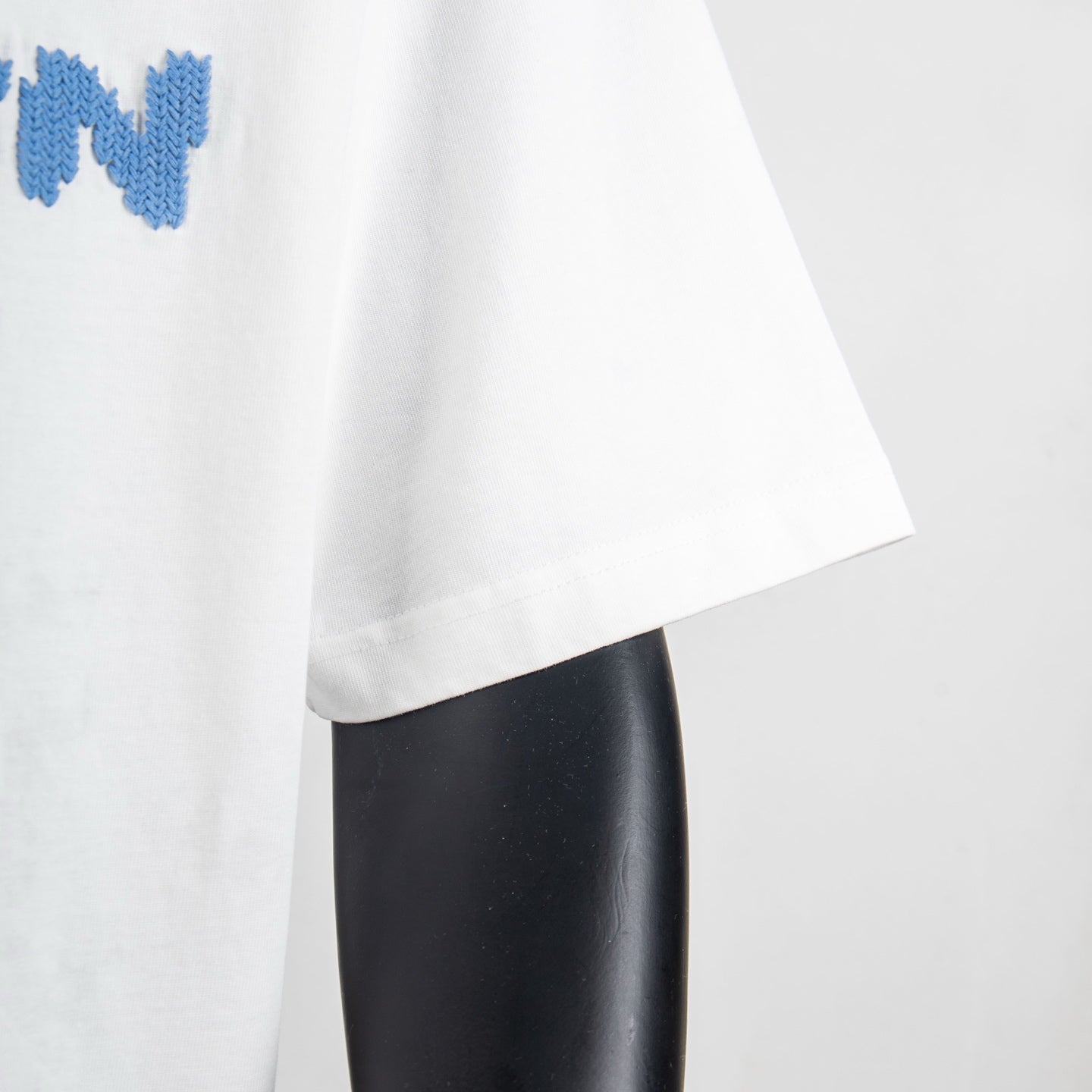White T-shirt sleeve and side hem detail