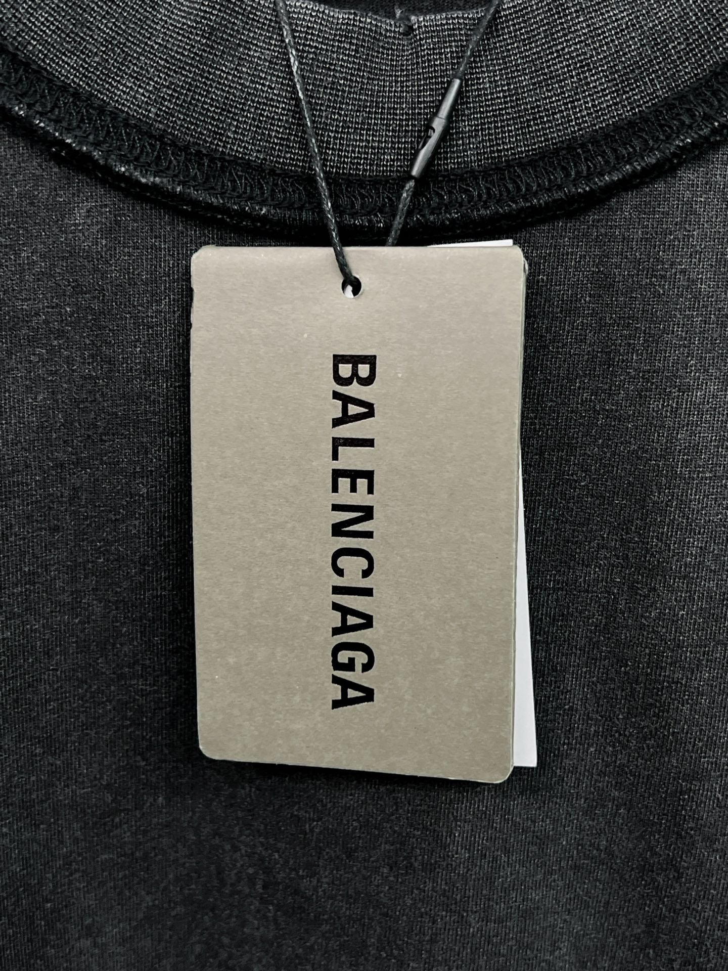Balenciaga neck label tag on black crewneck collar