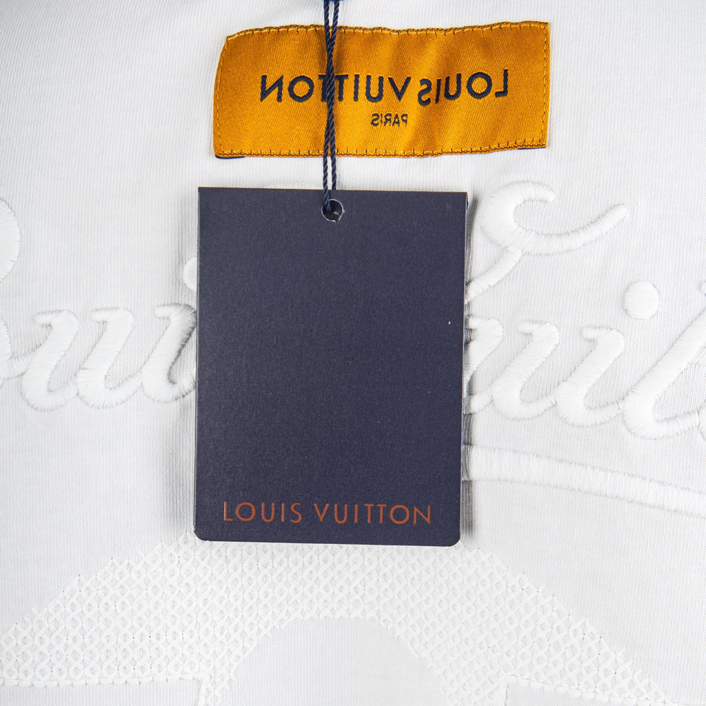 Louis Vuitton tag attached to white T-shirt with monogram logo