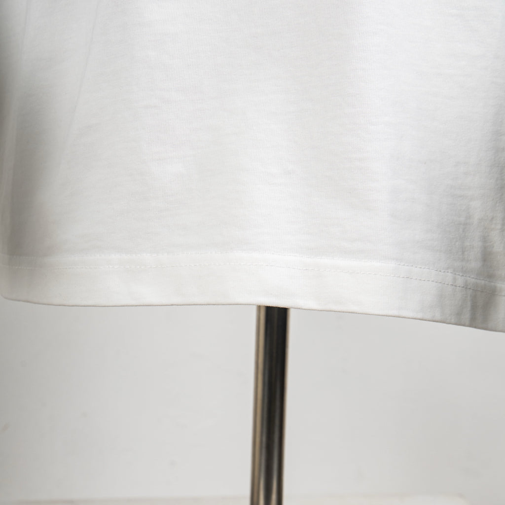Louis Vuitton white T-shirt with stitched lower hem and straight bottom edge.
