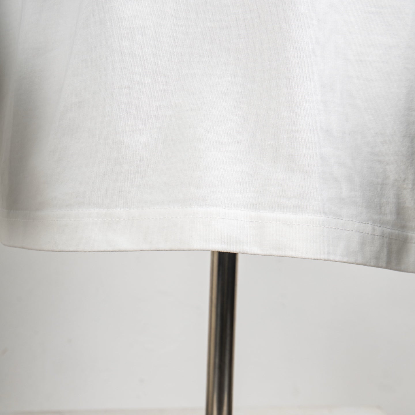 Louis Vuitton white T-shirt with stitched lower hem and straight bottom edge.