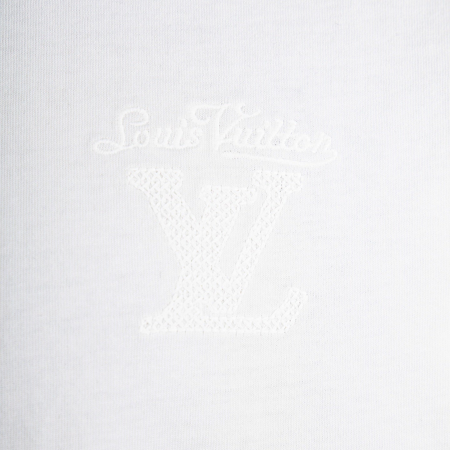 Louis Vuitton white T-shirt with subtle tonal 'Louis Vuitton' script logo.